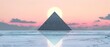 The image features a large triangular pyramid made of glass or metal, placed on a reflective surface that reflects the orange and yellow gradient sky