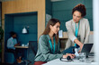 © Drazen - Female entrepreneurs cooperating while working on laptop in office.