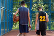Friends playing basketball Afro American and Caucasian players