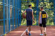 Basketball players playing together on summer playground
