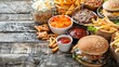Top view of various unhealthy fast foods on a wooden table. Concept Fast Food, Unhealthy Eating, Top View, Wooden Table, Food Photography