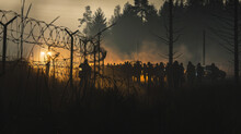 Silhouettes Against Dawn In A Forest With Barbed Wire Fence