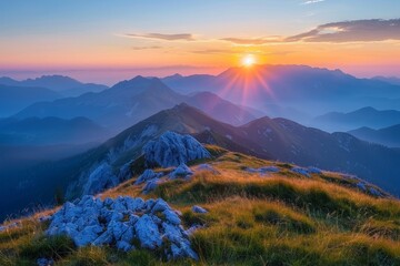 Poster - The sun ascends above the jagged peaks of the mountains in the background