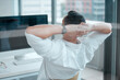 © peopleimages.com - Businessman, relax and desk in office for work with stretch at end of the day with screen for break from computer. Graphic design, back and table with project management with digital in creative