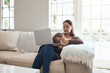 © peopleimages.com - Woman, laptop and credit card on couch for buy, finance and website for online shopping in home. Female person, ecommerce and code for payment or purchase, sofa and app for banking or budget on tech