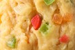 Texture of raw dough with candied fruits as background, top view