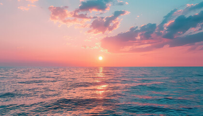 Wall Mural - A beautiful sunset over the ocean with a few clouds in the sky