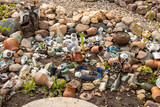 Fototapeta Natura - Old crockery and their fragments on the ground as an abstract background. Landscape design concept.