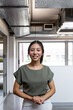 © Austockphoto - Asian woman standing confidentally in an industrial style creative office space