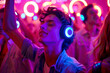 © Renata Hamuda - Young Man Enjoying Music with Headphones at Colorful silent Nightclub disco