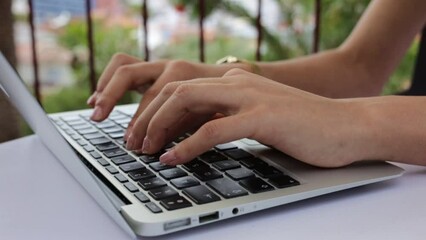 Close up of woman programmer working on terrace 