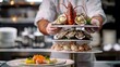 A chef presenting a gourmet seafood tower with oysters, lobster, and caviar
