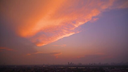 Wall Mural - Time lapse weather sunset over modern office buildings in business district. Skyline cirrus cloudscape view of cityscape with disc sun sunlight flare.