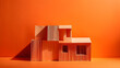 orange paper house nestled against a seamlessly matching orange backdrop
