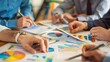 © Plaifah - A group of business partners discussing financial charts and graphs
