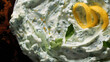 Fresh creamy greek tzatziki sauce close up with olive oil, dill and parsley background