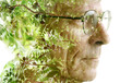 A double exposure profile of a man with glasses merged with a photo of plant