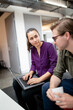 © Austockphoto - Aboriginal woman and Caucasian man sitting together in a break-out office area talking