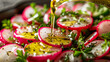 salad of slices of red and white radishes green herbs scattered throughout a stream of golden olive oil being drizzled on top