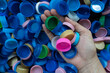 woman hand holding plastic bottles caps for recycling to conserve the environment, Recycling, reuse, garbage disposal, save the world concpet.