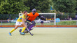 Young field hockey player in attack near the net