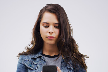 Canvas Print - Girl, student and phone for notification in studio, reading and university website for application. Woman, social media and internet for survey, communication and online dating app on gray background