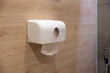 A roll of toilet paper is hanging on a wall
