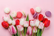 Pastel colorful tulips and vibrant macaroons