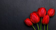 Red tulips grace the table, providing a serene and vibrant backdrop