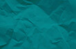 close up view of blue crumpled piece of construction paper use as background with blank space for design. blue creased crumpled paper backdrop.