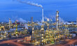 © industrieblick - refinery - chemical factory at night with buildings, pipelines and lighting - industrial plant