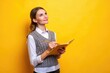 © Musarrof - Photo of smart woman dressed knitwear waistcoat hold copybook look at promo empty space write plan isolated on yellow color background