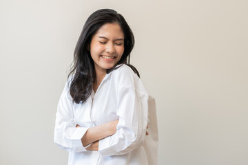 Wall Mural - Smile positive, happy asian young woman wearing casual shirt, portrait of beautiful female with black long hair feeling prond, standing crossed arms looking at camera, isolated on white background.