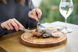 Lunch in a restaurant, a woman eats Pieces of liver cooked on the grill. Serving on a wooden Board. Barbecue restaurant menu, a series of photos of different meats.