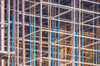 Construction background from mounted scaffolding on a construction site.