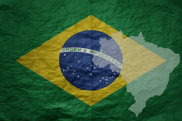 Wall Mural - big national flag and map of brazil on a grunge old paper texture background