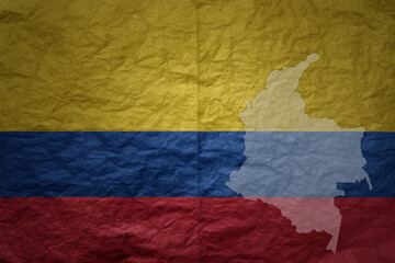 Wall Mural - big national flag and map of colombia on a grunge old paper texture background