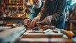 A close-up of an elderly couple's hands as they work together on a DIY project in their workshop, with tools and materials scattered around them. Dynamic and dramatic composition,