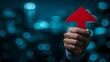 © Oleg - Successful businessman holding red upward arrow shows positive financial growth trend