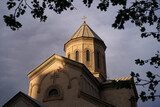 Fototapeta  - The Kashveti Church of St. George in central Tbilisi, located across from the Parliament building on Rustaveli Avenue. Dramatic light on dark clouds background.