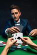 Upset poker player in casino with bad poker cards.