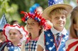 Three children wearing patriotic hats and outfits smiling at a Fourth of July parade, showcasing joy and national pride. 4th of July, american independence day, memorial day concept