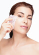 Elegant Woman Using Gua Sha Stone for Facial Care. Firming and Brightening Beauty Routine