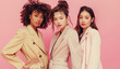 Fashion portrait of beautiful stylish multiethnic young women together, diverse girlfriends on pink