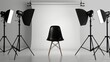 © Elchin Abilov - Lights from a photo studio, set against a white background, illuminating a black chair.