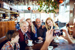 © Davor - Multi generational family posing for a photo in a Christmas decorated cafe