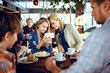© Davor - Happy young family sitting in cafe decorated for the Christmas holidays