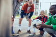 © Davor - Senior men resting and laughing together after soccer game in park