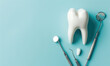 Model of a tooth and dental instruments. Dentistry concept background