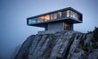 modern house on a rocky cliff side with fog surrounding it